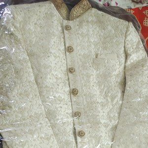 Beige colour sherwani with safa, stole ,jewellery and neckpiece